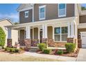 Inviting front porch with stone pillars, providing a welcoming entrance to the home at 16840 Rudence Ct, Charlotte, NC 28278