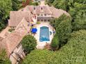 Luxury home with pool and extensive landscaping nestled in a wooded lot at 4231 Fox Brook Ln, Charlotte, NC 28211