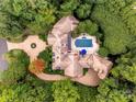 Luxury home with pool and extensive landscaping nestled in a wooded lot at 4231 Fox Brook Ln, Charlotte, NC 28211