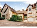 Stone home with 3-car garage and meticulously maintained landscaping at 4231 Fox Brook Ln, Charlotte, NC 28211