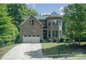 Two-story brick home with a driveway and mature trees at 7954 Rolling Creek Ct, Charlotte, NC 28270