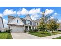 Two-story house with gray siding, stone accents, and a front porch at 145 Yellow Birch Loop, Mooresville, NC 28117