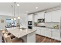 Bright kitchen features white cabinets, granite countertops, and stainless steel appliances at 145 Yellow Birch Loop, Mooresville, NC 28117