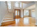 Two-story entryway with hardwood floors, a staircase, and large windows at 7954 Bay Pointe Dr, Denver, NC 28037