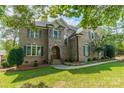 Brick house with gray shutters, landscaping, and a large front yard at 7954 Bay Pointe Dr, Denver, NC 28037