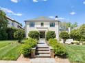 Modern white brick home with landscaped walkway leading to a double door entry at 1446 Queens W Rd, Charlotte, NC 28207