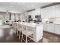 Modern kitchen with white cabinets, island, and breakfast bar at 411 Moondance Dr, Gastonia, NC 28054