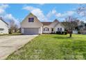 Inviting home featuring a two-car garage, manicured lawn and traditional facade at 416 Linsbury Ct, Gastonia, NC 28056