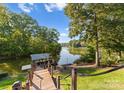 Private dock on the lake with covered boat storage, providing direct water access and scenic views at 4145 Cindy Ln, Denver, NC 28037