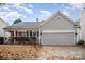 Gray exterior ranch home with two-car garage at 10423 Brawley Ln, Charlotte, NC 28215