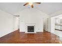 Bright living room featuring hardwood floors and a charming fireplace at 10423 Brawley Ln, Charlotte, NC 28215