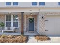 Inviting front porch with stylish door and brick columns at 2036 White Cypress Ct # Kh10, Charlotte, NC 28216