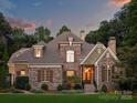 Stunning stone and shingle two-story home with landscaping at 13824 Claysparrow Rd, Charlotte, NC 28278