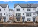 Row of new construction townhomes with neutral siding, brick accents, and professionally landscaped yards at 1617 Blanche St, Charlotte, NC 28262