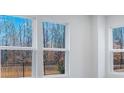 Sun-filled living room featuring hardwood floors and three large windows offering natural light at 1617 Blanche St, Charlotte, NC 28262