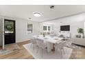 Entryway with black front door, and views into living and dining area at 217 Burrage Ne Rd, Concord, NC 28025