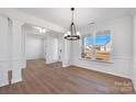 Dining room with stylish light fixture, paneled walls, and large windows at 5735 Allburn Pkwy, Concord, NC 28027