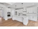 Gourmet kitchen with stainless appliances, a large island, and abundant white cabinetry at 5735 Allburn Pkwy, Concord, NC 28027