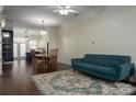 Open living and dining area with teal sofa and view into the kitchen at 11770 Redbridge Blvd, Locust, NC 28097