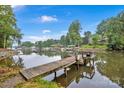 Picturesque dock extending into the lake, offering a peaceful waterfront escape with scenic views of surrounding docks and nature at 470 Lakeview Shores Loop, Mooresville, NC 28117