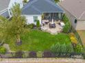 Aerial view showcasing a spacious backyard with patio, landscaping, and a screened porch at 494 Bowline Dr, Denver, NC 28037