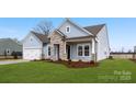Attractive one-story home featuring stone accents, a two-car garage, and a well-maintained lawn at 3228 Gavin Ln, Harrisburg, NC 28075