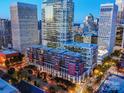 Stunning aerial view of the building surrounded by city skyscrapers at dusk at 435 S Tryon St # 301, Charlotte, NC 28202