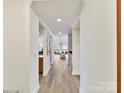 Inviting hallway with hardwood floors and access to living spaces at 435 S Tryon St # 301, Charlotte, NC 28202