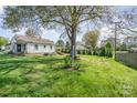 Expansive backyard with lush green lawn and mature trees, providing ample space for outdoor activities at 630 S Myrtle School Rd, Gastonia, NC 28052