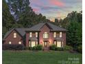 Two-story brick home on large lot with landscaped front yard at 907 Weymouth Dr, Gastonia, NC 28056