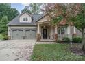 Tan house with a two-car garage and a lovely front yard at 3150 Helmsley Ct, Concord, NC 28027