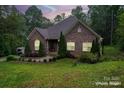 Charming single-story brick home featuring manicured landscaping and a well-maintained lawn at 10604 Russet Pl, Charlotte, NC 28227