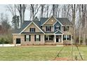 Two-story brick home featuring dark shutters, attached two car garage, and manicured front lawn at 8605 Carly Ln, Mint Hill, NC 28227