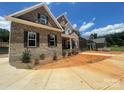 Attractive two-story brick home featuring a covered front porch and professional landscaping, enhancing its curb appeal at 8605 Carly Ln, Mint Hill, NC 28227