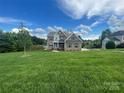 Lovely brick home surrounded by lush greenery, offering tranquil lake views at 9411 Stonebridge Way # 49, Mint Hill, NC 28227