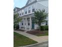 Two-story townhome with gray siding, front porch, and landscaping at 13969 Clayborn St, Midland, NC 28107