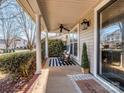 A rocking chair sits on the porch, enjoying the morning sun at 11612 Kingsley View Dr, Charlotte, NC 28277