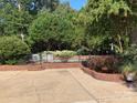 Lovely backyard with a patio, garden beds, and partial view of the swimming pool at 24756 Strand Dr, Albemarle, NC 28001