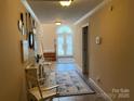 Inviting foyer with tiled floors, decorative rugs and a charming, arched window door at 24756 Strand Dr, Albemarle, NC 28001