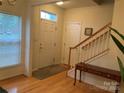 Inviting foyer featuring hardwood floors, staircase and natural light from window at 4016 Holly Villa Cir, Indian Trail, NC 28079