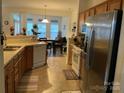 Well-lit kitchen with stainless steel appliances and an open concept to the dining area at 4016 Holly Villa Cir, Indian Trail, NC 28079