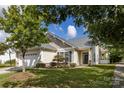 Charming single Gathering house with a well-manicured lawn and an attached two-car garage at 1041 Kensrowe Ln, Matthews, NC 28104