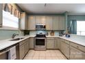 Kitchen with stainless steel appliances, tile backsplash, white countertops and tile flooring at 1041 Kensrowe Ln, Matthews, NC 28104