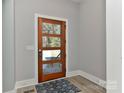 Modern entryway with a wooden door and a rug at 569 Evergreen Rd, Clover, SC 29710