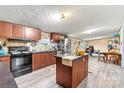 Well-lit kitchen with a center island, wood cabinets and stainless steel appliances at 7686 Hickory Creek Dr, Denver, NC 28037