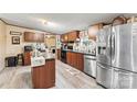 Kitchen showcasing stainless steel appliances, wood cabinets, and a kitchen island at 7686 Hickory Creek Dr, Denver, NC 28037