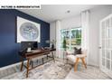 Bright office space with a desk, chair, large window, and stylish decor at 107 Rustling Waters Dr, Mooresville, NC 28117