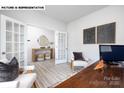 Inviting office space with french doors, neutral tones, and modern furniture at 107 Rustling Waters Dr, Mooresville, NC 28117