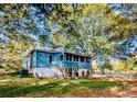 Blue house exterior with screened porch and large trees at 5011 Lewis Rd, Gastonia, NC 28052