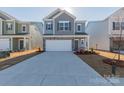 Charming two-story home with a two-car garage, gray door and blue siding at 1209 Red River Dr, Salisbury, NC 28144